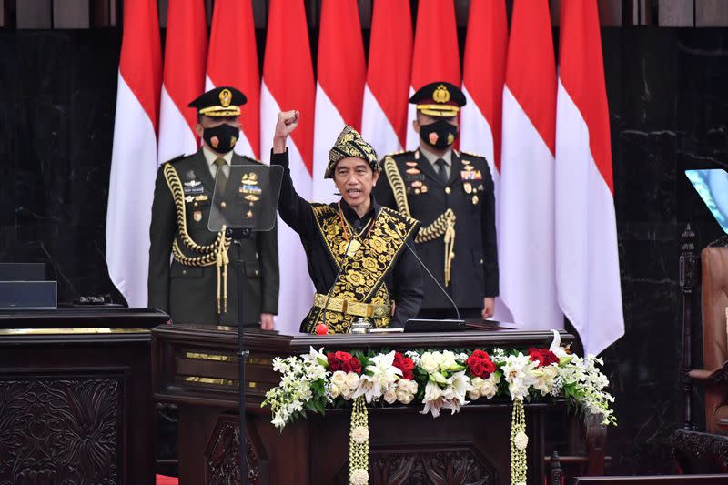 Indonesian President Joko Widodo dressed in a traditional Indonesian traditional costume from Sabu, gestures as he delivers a speech ahead of the 75th Independence Day, at the parliament building in Jakarta