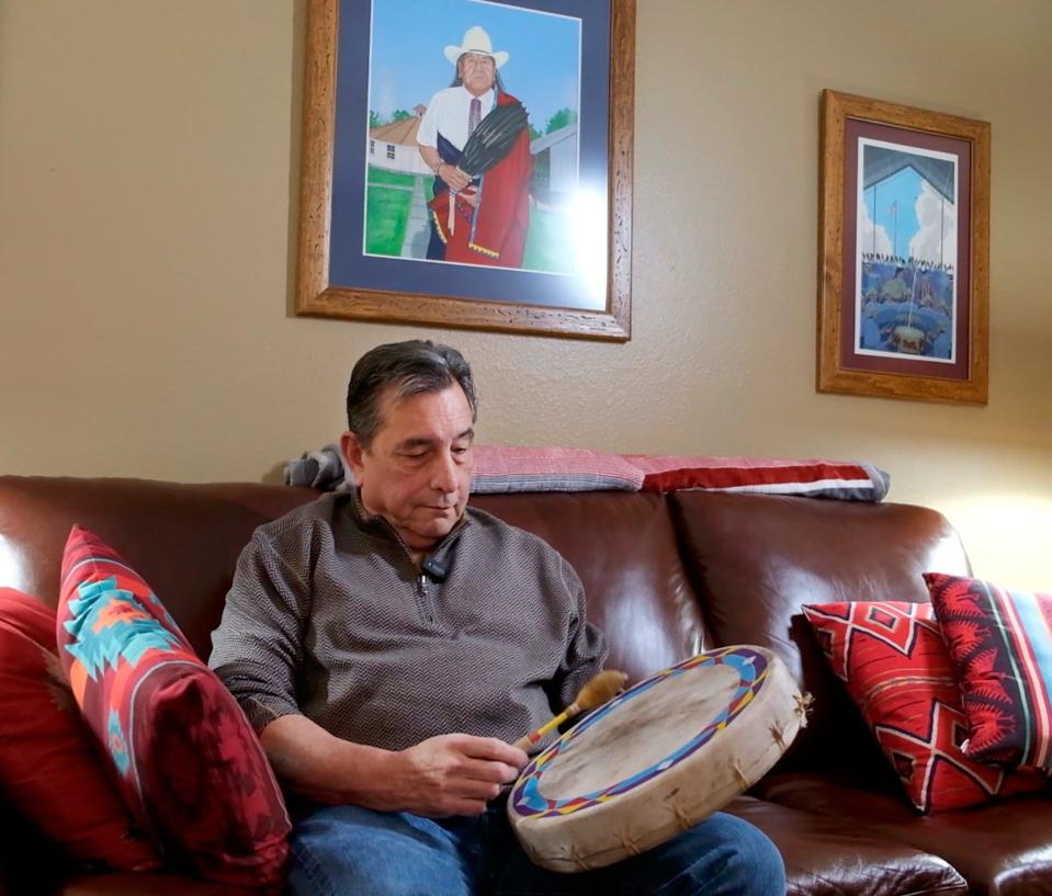 Scott George sits under a portrait he painted of one of his mentors, the late Morris Lookout, at his home in Del City on Feb. 22. The first Osage Academy Award nominee, George wrote for the movie "Killers of the Flower Moon" the Oscar-nominated original song "Wahzhazhe (A Song For My People)." He is the first Indigenous nominee in the original song category in Oscars history.