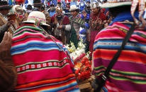 Supporters of presidential candidate Luis Arce from the Movement Towards Socialism Party, MAS, surround an offering to the "Pachamama," or Mother Earth during his closing campaign rally in El Alto, Bolivia, Wednesday, Oct. 14, 2020. Elections will be held Oct. 18. (AP Photo/Juan Karita)