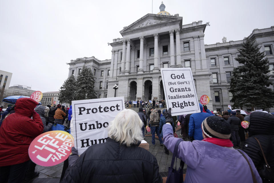 FILE - Attendees protest the one-year anniversary of Colorado's abortion law, the Reproductive Health Equity Act, Tuesday, April 4, 2023, outside the State Capitol in downtown Denver. A Colorado abortion fund said Thursday, May 9, 2024, it's helped hundreds access abortion in the first months of 2024, many arriving from Texas and other states where abortion is restricted, showing a continued increase in demand since the U.S. Supreme Court overturned Roe v. Wade in 2022. (AP Photo/David Zalubowski, File)