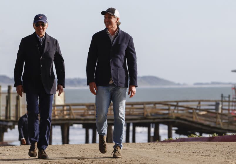 President Joe Biden is joined by California Governor Gavin Newsom as he tours the damage done to Seacliff Pier and Seacliff State Beach in Aptos, Calif., on Thursday, Jan. 19, 2023, while on a tour to assess damage caused by a series of major storms. (Jessica Christian/San Francisco Chronicle via AP)