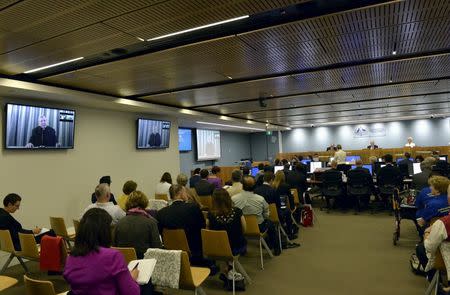 Screens displaying Australian Cardinal George Pell appearing via video link from a hotel in Rome, Italy can be seen inside Australia's Royal Commission into Institutional Response to Child Sexual Abuse in Sydney, Australia, February 29, 2016. REUTERS/Jeremy Piper-Oculi/Handout via Reuters