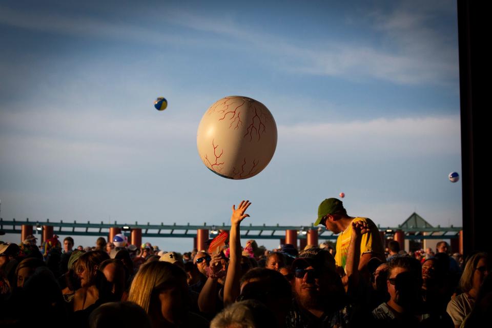 People throw beach balls into the air during the Jimmy Buffett & The Coral Reefer Band concert at Riverbend Music Center on Thursday, July 18, 2019.