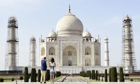 Britain's Prince William and his wife Catherine, the Duchess of Cambridge, look at the Taj Mahal in Agra, India, April 16, 2016. REUTERS/Money Sharma/Pool