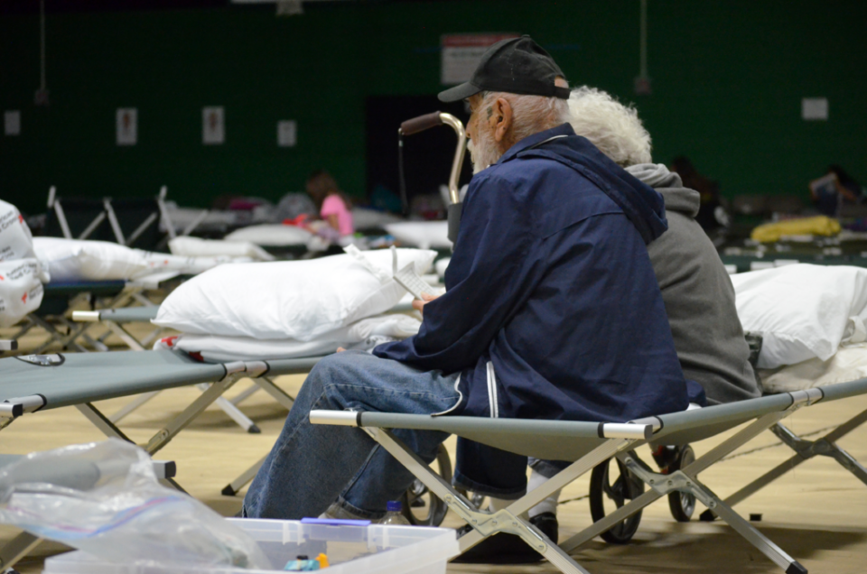 A couple wait together in the Eastern New Mexico University gymnasium Tuesday, June 18, 2024 after evacuating the Ruidoso area because of the South Fork and Salt fires