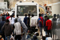 Migrants line up to get on a police bus after they disembarked from an Armed Forces of Malta patrol boat at its base in Marsamxett Harbour, Valletta, Malta May 25, 2019. REUTERS/Darrin Zammit Lupi