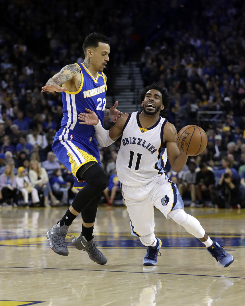 Memphis Grizzlies' Mike Conley (11) dribbles next to Golden State Warriors' Matt Barnes during the first half of an NBA basketball game Sunday, March 26, 2017, in Oakland, Calif. (AP Photo/Marcio Jose Sanchez)
