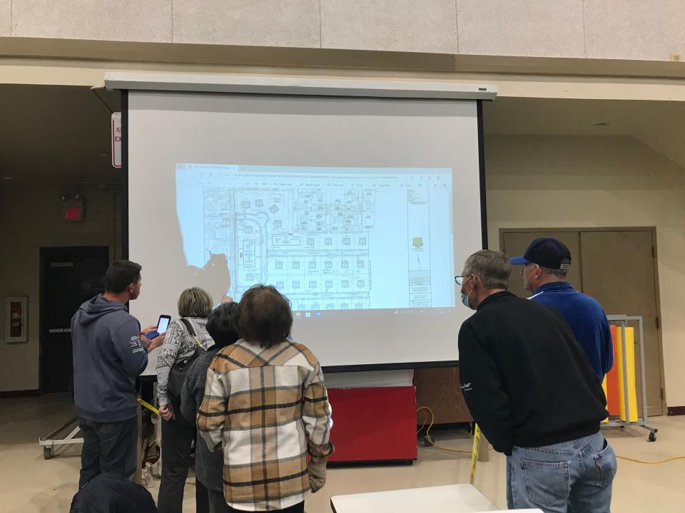 At a special Brick Planning Board meeting on Monday, township residents review DR Horton's plans to build 59 new single family homes in Breton Woods, one of the last forested parcels in Brick.