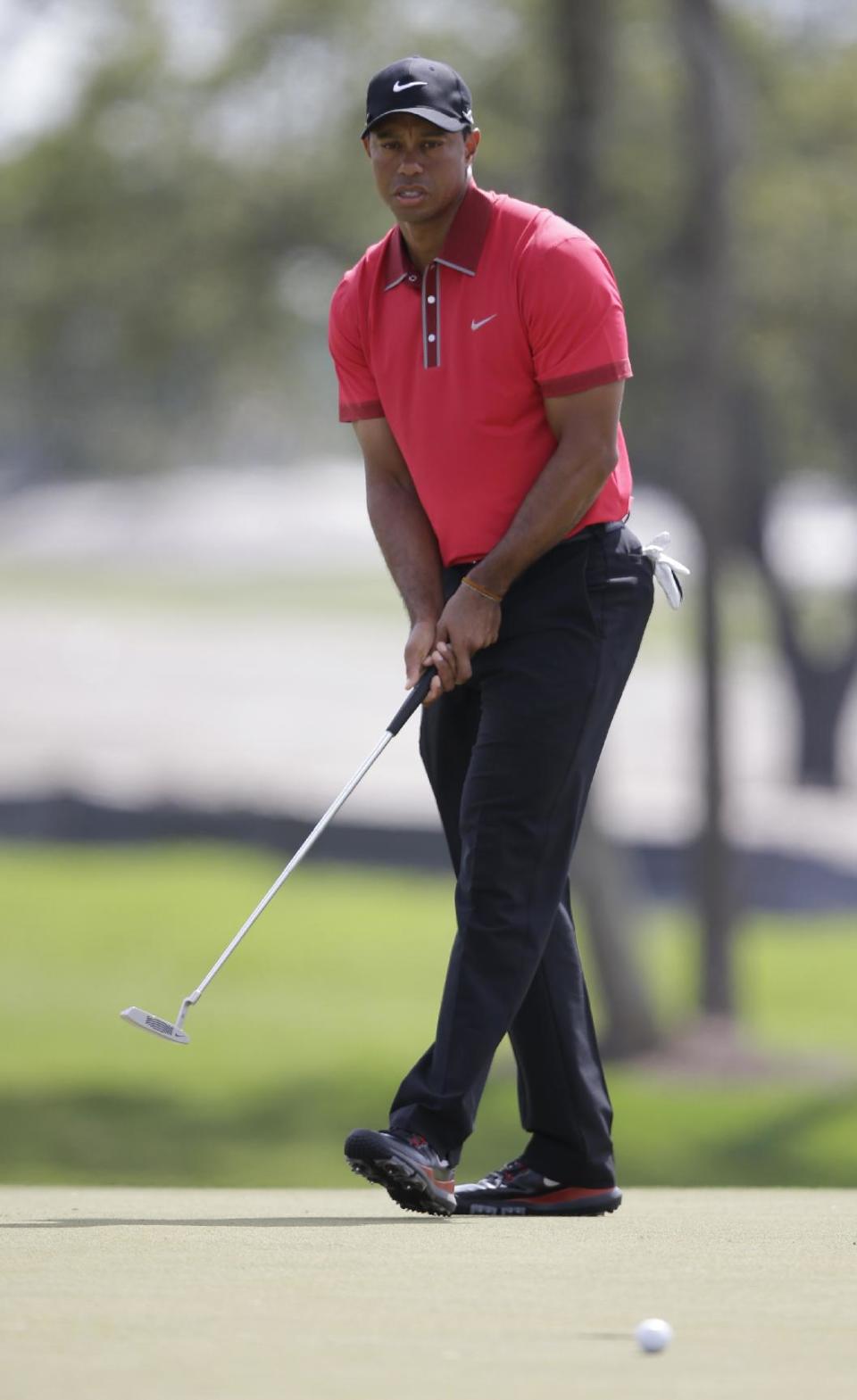 Tiger Woods watches his ball miss the second hole cup during the final round of the Cadillac Championship golf tournament on Sunday, March 9, 2014, in Doral, Fla. Woods made par. (AP Photo/Wilfredo Lee)