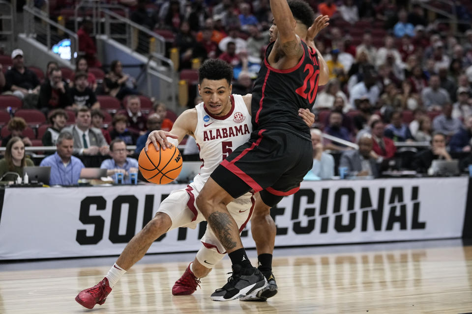 Alabama guard Jahvon Quinerly (5) moves against San Diego State guard Matt Bradley (20) in the first half of a Sweet 16 round college basketball game in the South Regional of the NCAA Tournament, Friday, March 24, 2023, in Louisville, Ky. (AP Photo/John Bazemore)