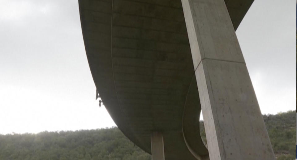 In this image taken from video provided by eNCA, a bus carrying worshippers headed to an Easter festival plunged off a bridge on a mountain pass and burst into flames in Limpopo, South Africa, on Thursday, March 28, 2024, killing multiple people, authorities said. (eNCA via AP)