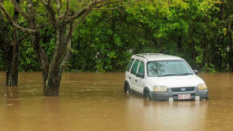 A car inundated with water near the Barron River in Cairns, Australia, on Decebmer 16, 2023. - Joshua Prieto/AAP/AP