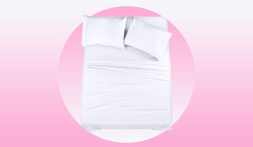 A bed with white sheets and two pillows.