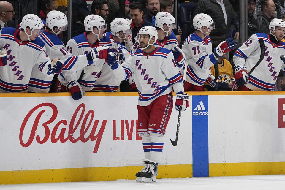 New York Rangers center Vincent Trocheck (16) celebrates a goal with teammates during the second period of an NHL hockey game against the Nashville Predators, Saturday, Dec. 2, 2023, in Nashville, Tenn. (AP Photo/George Walker IV)