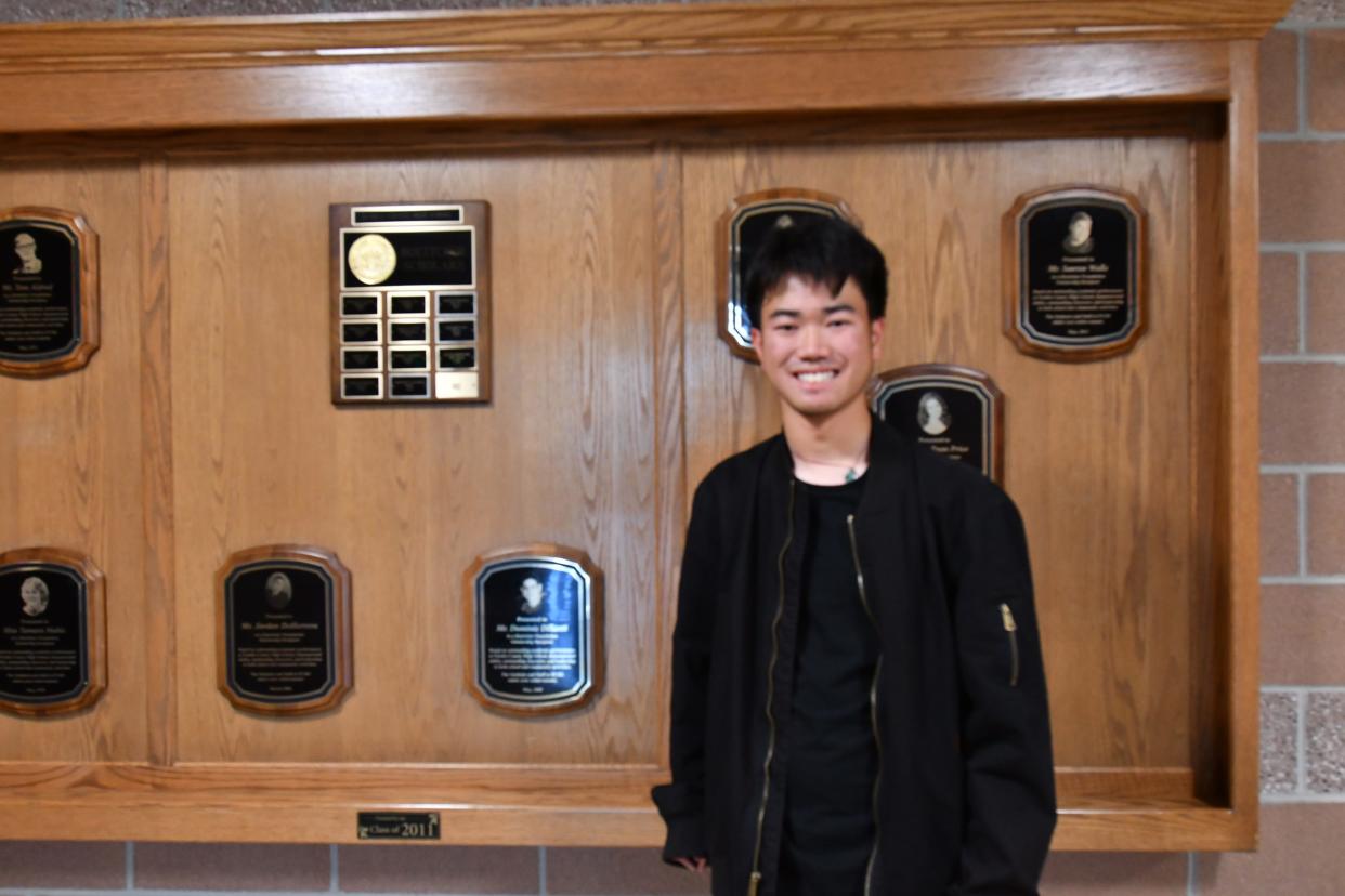 Li Hong Sweet-Seip is pictured in front of the wall of fellow Boettcher scholars at Pueblo County High School.