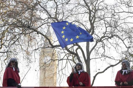 Protesters wearing judges' wigs and robes ride an open top bus past the Supreme Court ahead of the challenge against a court ruling that Theresa May's government requires parliamentary approval to start the process of leaving the European Union, in Parliament Square, central London, Britain December 5, 2016. REUTERS/Toby Melville