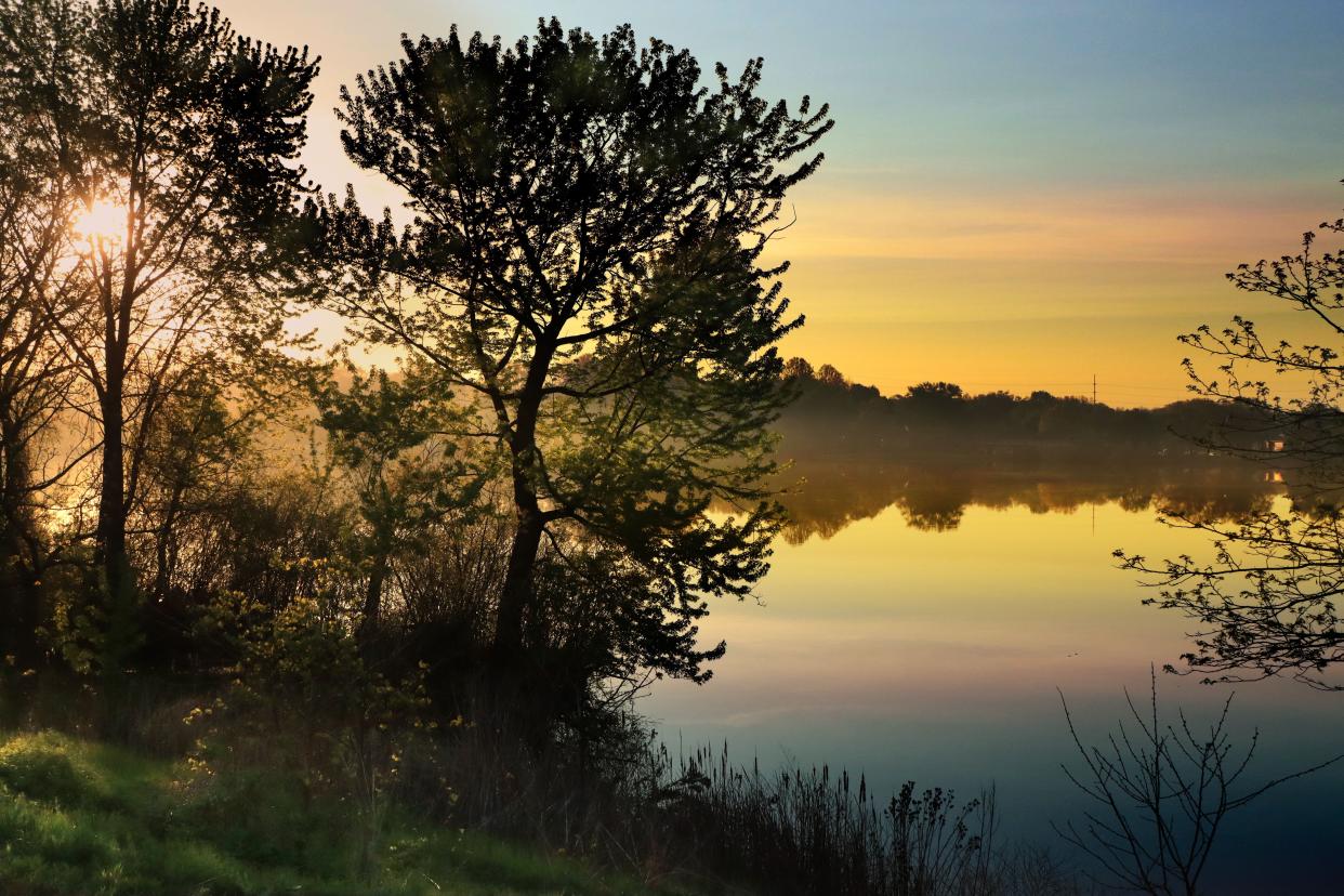 A morning mist rises over Summit Lake in Akron.