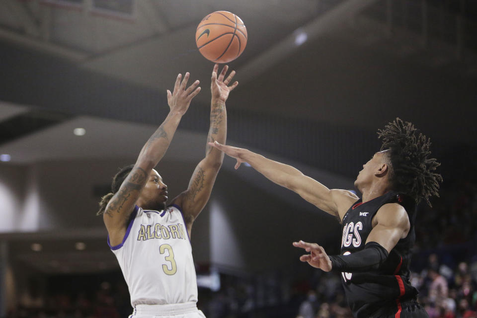 Alcorn State guard Justin Thomas, left, shoots over Gonzaga guard Hunter Sallis during the first half of an NCAA college basketball game Monday, Nov. 15, 2021, in Spokane, Wash. (AP Photo/Young Kwak)