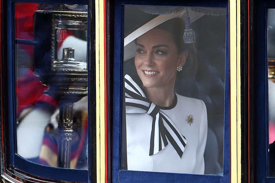 Princess Kate smiles inside the Glass State Coach on her way to Horse Guards Parade for Trooping the Colour, an event celebrating King Charles' birthday, in London on June 15, 2024. It was her first public appearance since she revealed her cancer diagnosis.