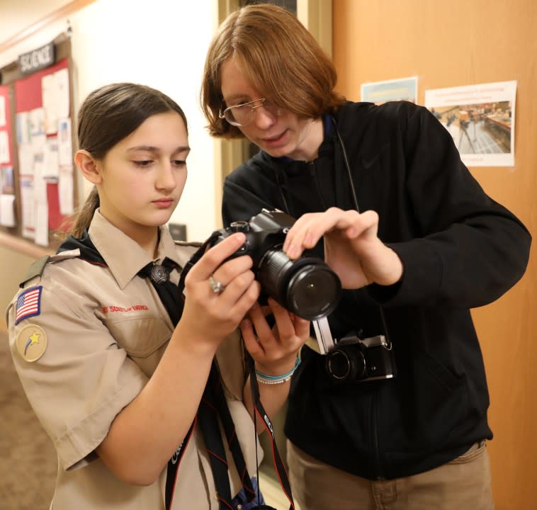 Merit Badge University instructor Simon Anderson shows Scout Elaina Wilson, 11, of Bettendorf, how to use her camera’s settings on Saturday morning in the Center for Science and Business at Monmouth College (Monmouth College)