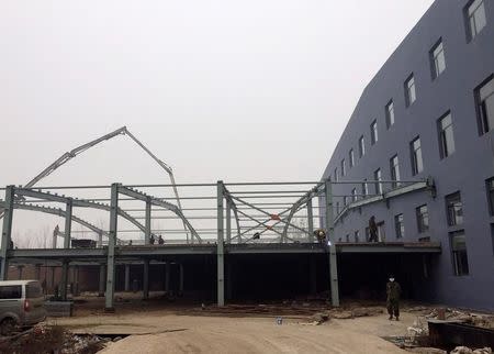 Workers at a new building of a toilet factory being built in Tangshan, Hebei province, China, November 18, 2016. Picture taken November 18, 2016. REUTERS/Elias Glenn