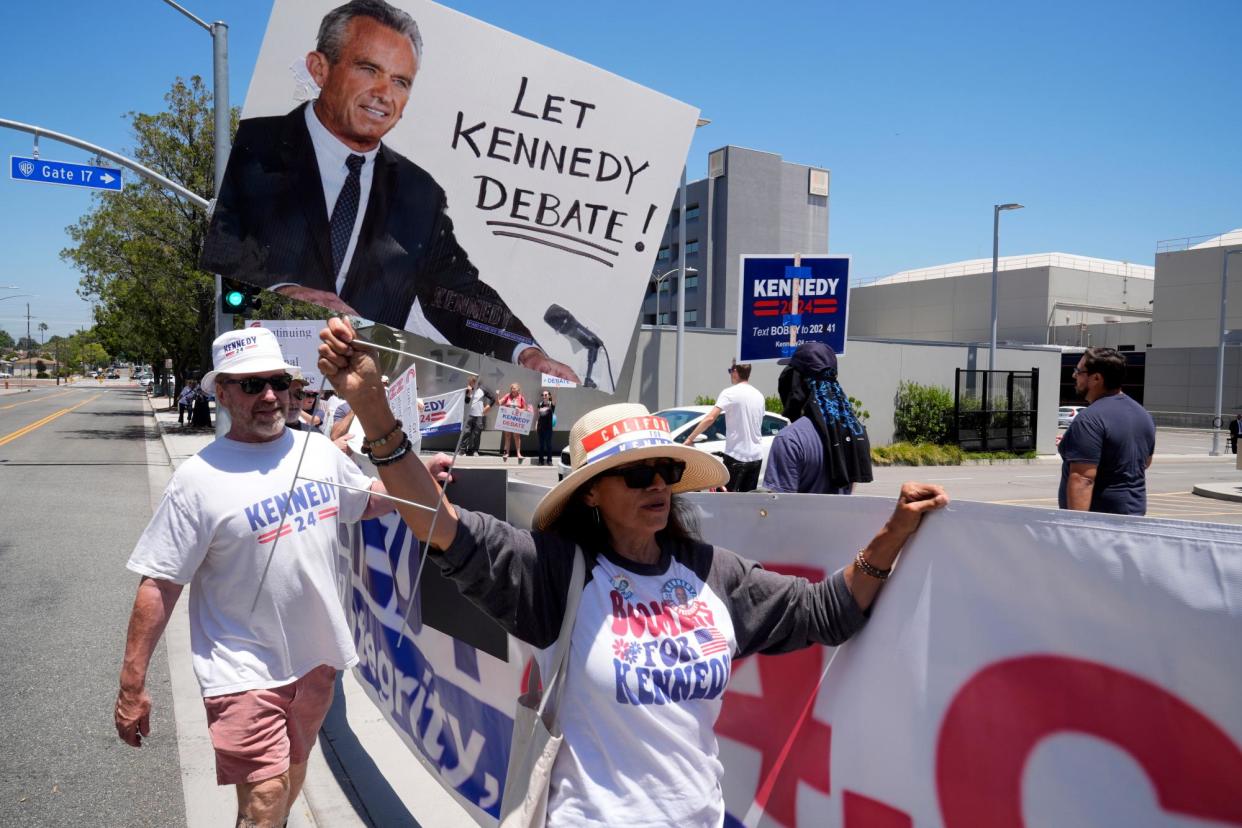 <span>Supporters of Robert F Kennedy Jr protest outside the studios of Warner Bros, CNN’s parent company, in Burbank, California, on 21 June 2024. </span><span>Photograph: Damian Dovarganes/AP</span>