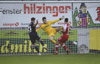 Berlin's Grischa Proemel, left, scores against Freiburg's goalkeeper Florian Mueller, center, the opening goal during the German Bundesliga soccer match between SC Freiburg and 1. FC Union Berlin in Freiburg, Germany, Saturday, Feb. 20, 2021. (Sebastian Gollnow/dpa via AP)