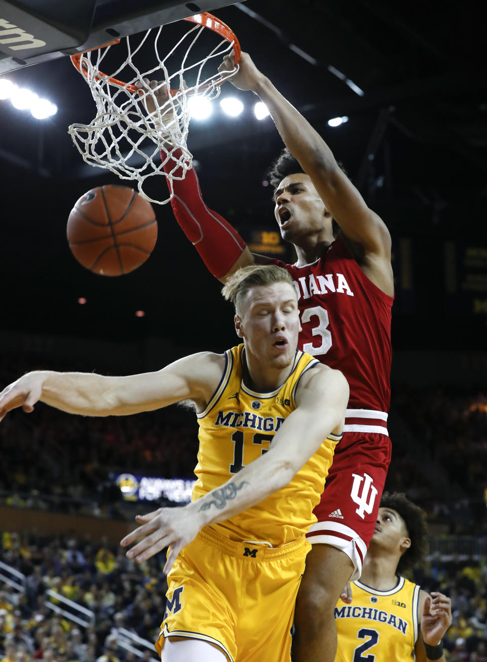 Indiana forward Justin Smith (3) dunks on Michigan forward Ignas Brazdeikis (13) in the first half of an NCAA college basketball game in Ann Arbor, Mich., Sunday, Jan. 6, 2019. (AP Photo/Paul Sancya)