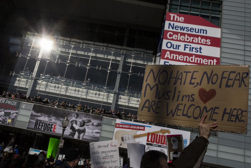 Demonstrators walk past the Newseum while marching from the White House to the Capitol Building on February 4, 2017 in Washington, DC. The demonstration was aimed at President Donald Trump's travel ban policy.&nbsp;