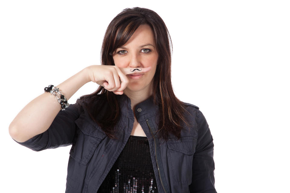 A woman with a mustache on her finger