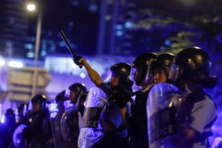 Riot police officers stand guard outside the Legislative Council during a protest to demand authorities scrap a proposed extradition bill with China in Hong Kong