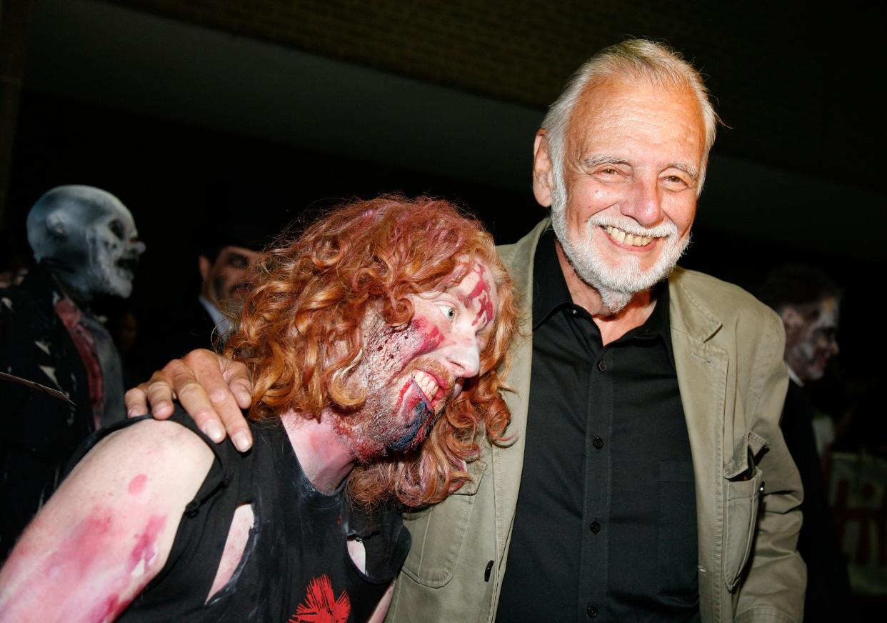 Director George A. Romero and a zombie arrive at the "Survival of the Dead" Midnight Madness screening during the 2009 Toronto International Film Festival.