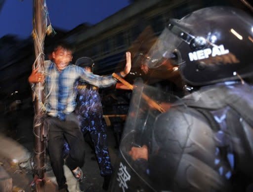 Nepalese police baton charge activists from the Brahmin-Chhetri Society outside the Constituent Assembly building in Kathmandu. The leader of Nepal's Maoists has called for rival parties to join a national unity government to take the country to fresh elections and said he was open to a change of prime minister