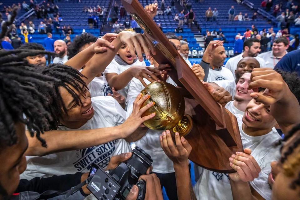 Warren Central players celebrate with the trophy after winning Kentucky’s 2023 boys’ high school basketball state championship in Rupp Arena on Saturday night.
