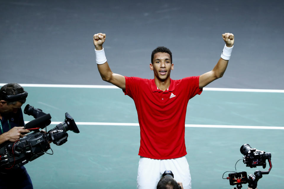 Canada's Felix Auger Aliassime celebrates after defeating Australia's Alex de Minaur during the final Davis Cup tennis match between Australia and Canada in Malaga, Spain, Sunday, Nov. 27, 2022. (AP Photo/Joan Monfort)