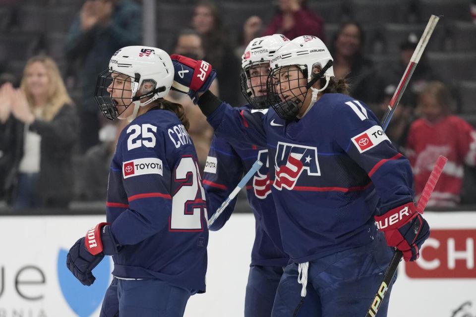 U.S. forward Alex Carpenter (25) celebrates with forward Hilary Knight (21) and forward Abby Roque.