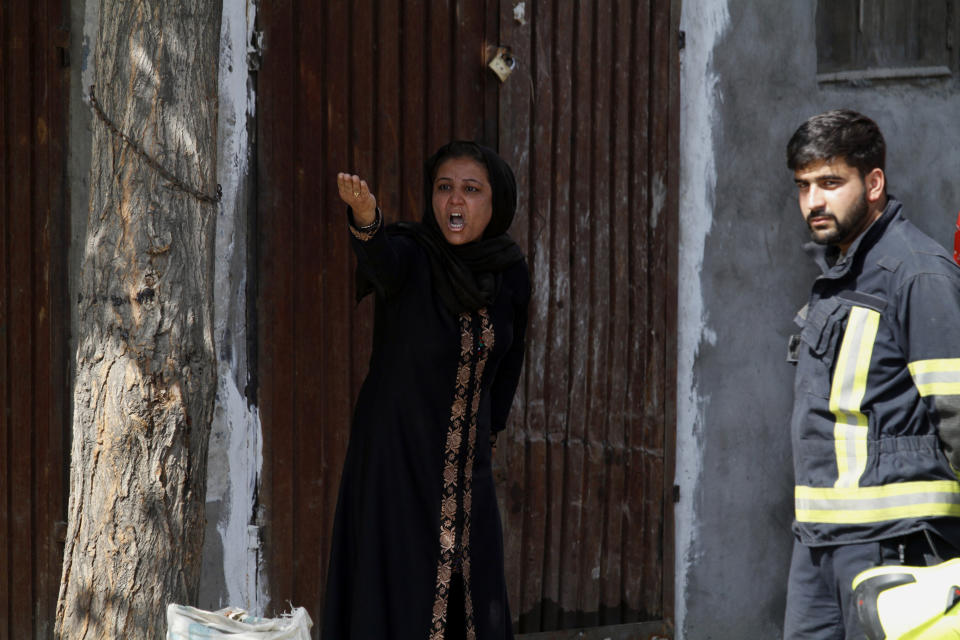 An Afghan woman shouts to protest against the Afghan government after an explosion near her home in Kabul, Afghanistan, Wednesday, Sept. 9, 2020. Spokesman for Afghanistan's Interior Ministry said the bombing that targeted the convoy of the country's first vice president on Wednesday morning killed several people and wounded more than a dozen others, including several of the vice president's bodyguards. (AP Photo/Rahmat Gul)