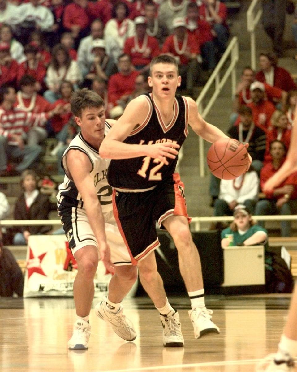 LaPorte's Greg Tonagel drives up the floor as Elkhart Central's Matt Dowell follows closely behind in March 1998.