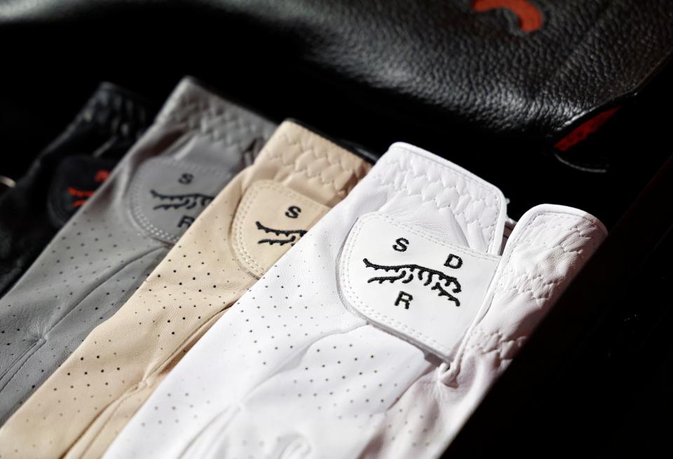 PACIFIC PALISADES, CALIFORNIA - FEBRUARY 12: A detail of gloves during the launch of Tiger Woods and TaylorMade Golf's new apparel and footwear brand "Sun Day Red" at Palisades Village on February 12, 2024 in Pacific Palisades, California. (Photo by Kevork Djansezian/Getty Images)