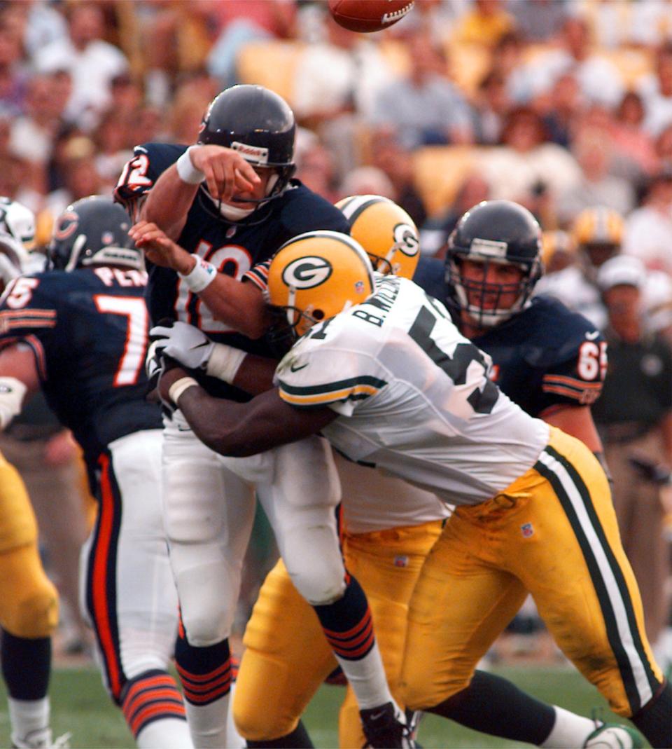 Chicago Bears quarterback Erik Kramer is hit by Green Bay Packers linebacker Brian Williams after getting the pass off.