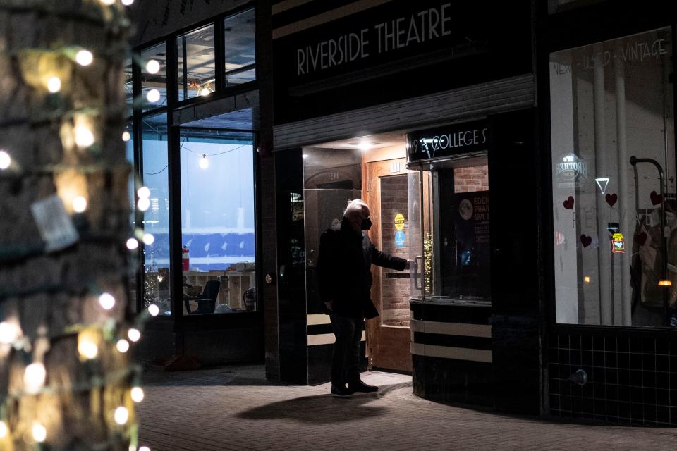 An attendee opens the door to Riverside Theatre's new location on the Ped Mall during its grand opening on Friday, Feb. 4, 2022. At the grand opening, "Eden Prairie, 1971" was performed in the theater.