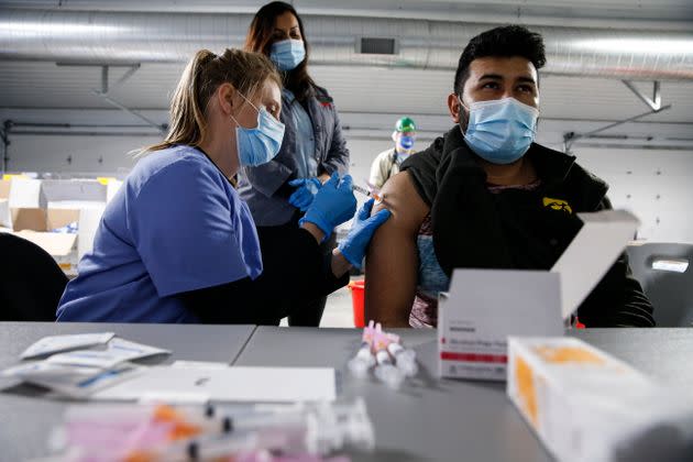 Tyson Foods workers receive COVID-19 vaccines from health officials at the facility in Joslin, Illinois.  (Photo: John Konstantaras/AP Images for Tyson Foods)