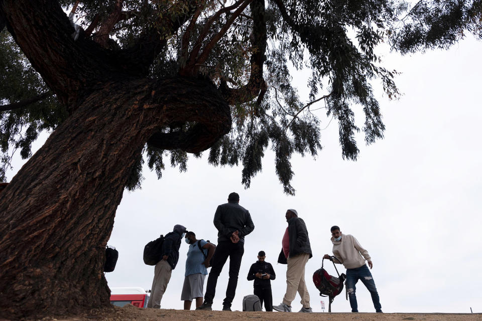 Image: migrants processed (Gregory Bull/AP file)