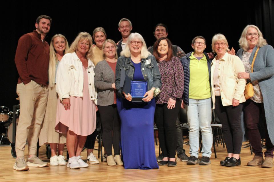 Susan Thies (center, with plaque) poses for a photo surrounded by her colleagues after being named the 36th Annual Dr. John W. Harris Teacher of the Year for the Sioux Falls School District at Ben Reifel Middle School on Feb. 26, 2024.