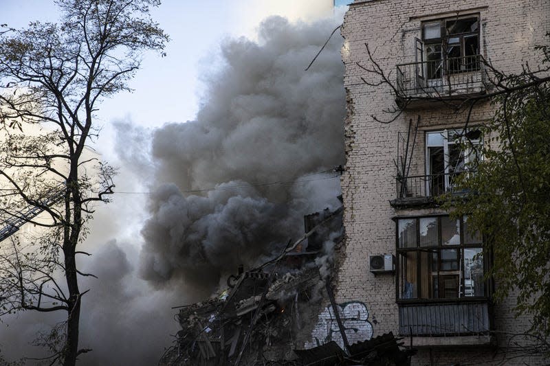 Smoke rises from a destroyed building after Russian attacks in Kyiv, Ukraine on October 17, 2022. 