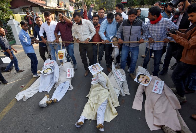 Demonstrators carry effigies during a protest against the Citizenship Amendment Bill, in Guwahati