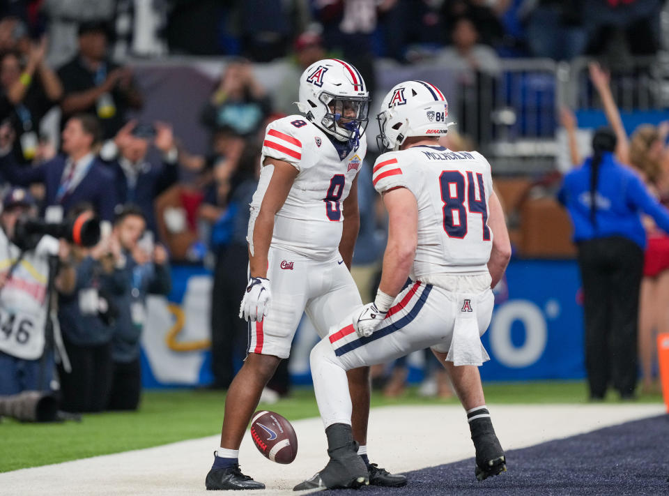 Dec 28, 2023; San Antonio, TX, USA; Arizona Wildcats running back DJ Williams (8) celebrates a touchdown with tight end Tanner McLachlan (84) in the second half against the Oklahoma Sooners at Alamodome. Mandatory Credit: Daniel Dunn-USA TODAY Sports