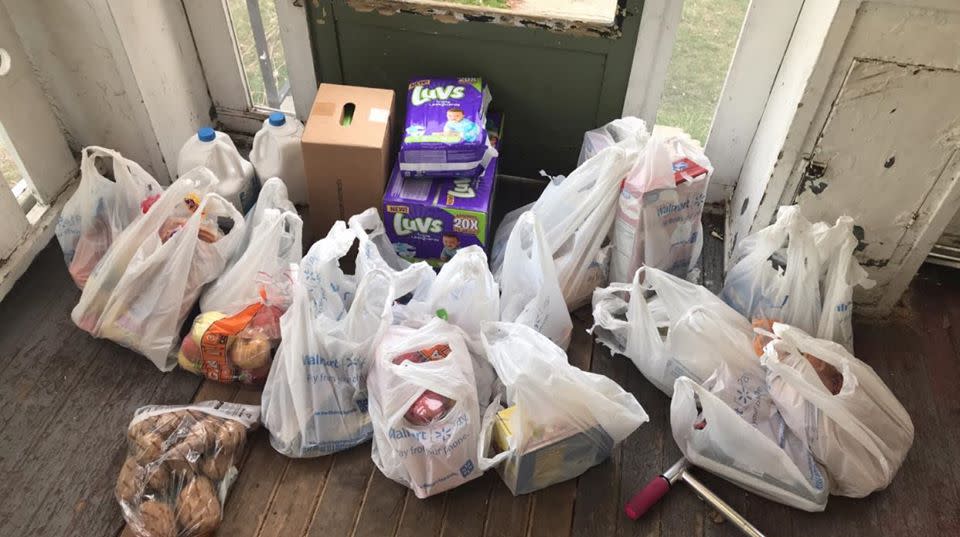 Bags of groceries are pictured.