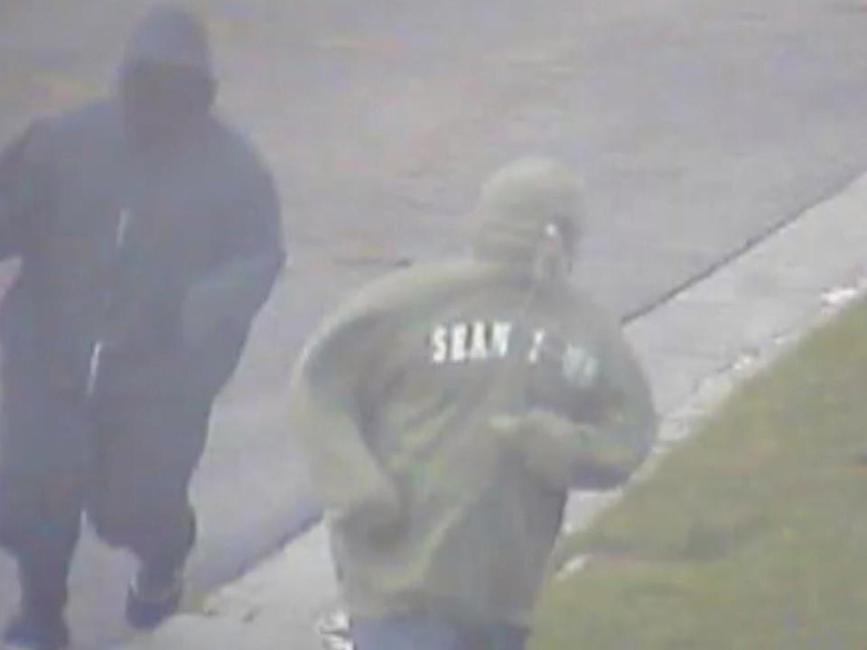 The murder suspects are seen on a neighbor's security camera running towards the Sementilli home on Jan. 27, 2017 at 4:18 p.m. Police say Robert Bakee is in the green hoodie. 