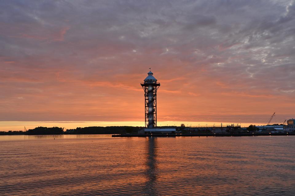 The sun rises over the Bicentennial tower at Dobbins Landing on Presque Isle Bay in Erie.